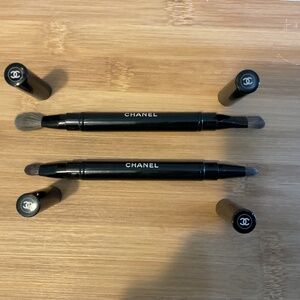 Two CHANEL travel sized eye makeup brushes.